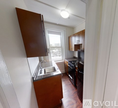 A kitchen with a sink and a refrigerator.
