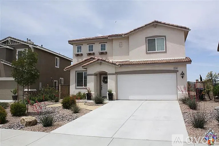 A house with a white garage door and a brown roof.
