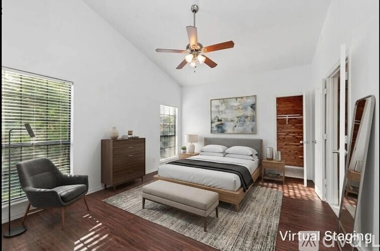 A bedroom with a bed, dresser, and chair.