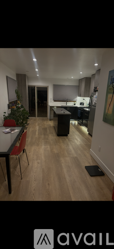 A room with a dining table and chairs.