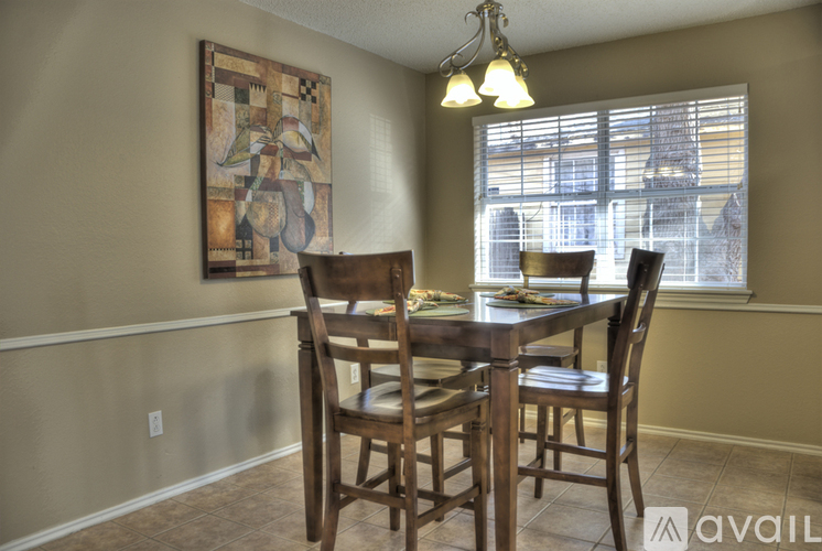 A dining room with a wooden table and chairs.