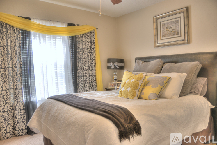 A bedroom with a large bed and a ceiling fan.