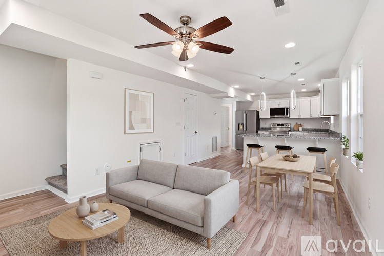 A living room with a grey couch and a wooden coffee table.