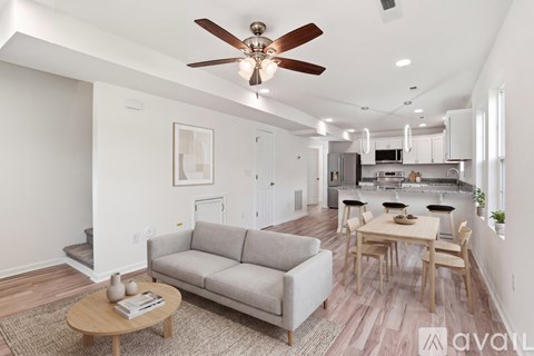 A living room with a grey couch and a wooden coffee table.