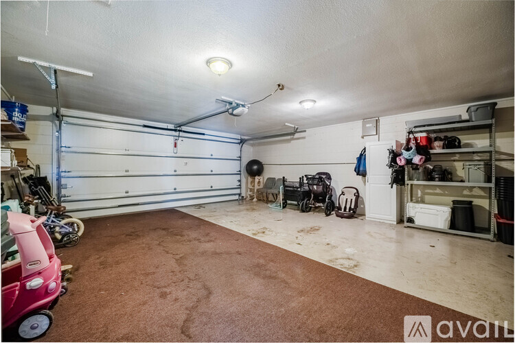 A spacious garage with a brown carpet floor and a white ceiling.