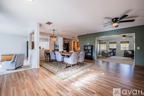 A living room with a dining table and chairs.
