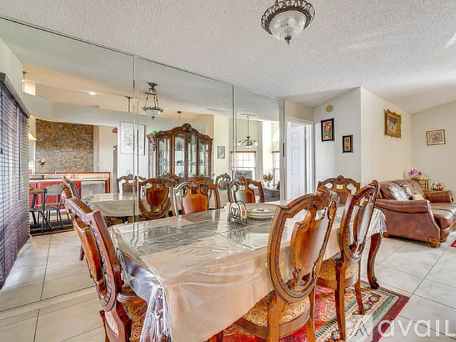 A dining room with a glass table and chairs.