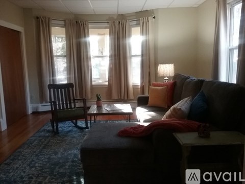 A living room with a couch, chair, and table.