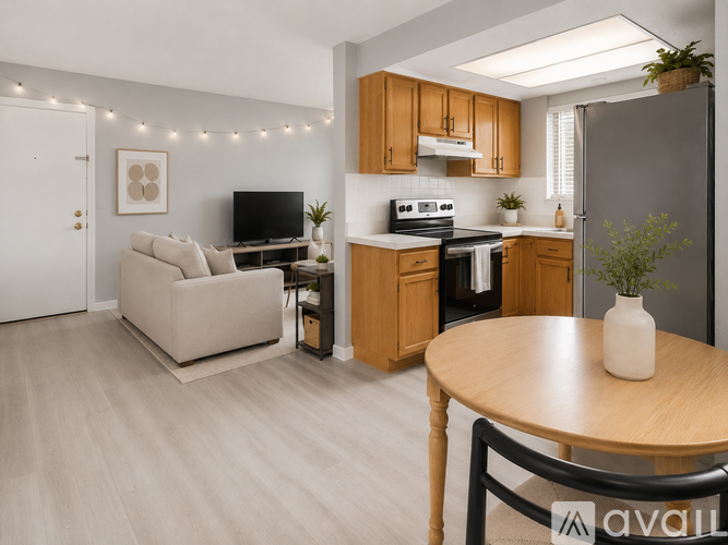 A modern kitchen with wooden cabinets and a beige sofa.