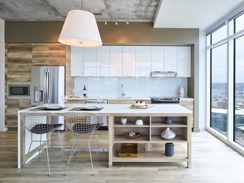 A modern kitchen with a dining table and chairs.
