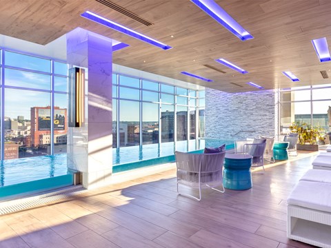 A modern room with a pool and a view of the city.