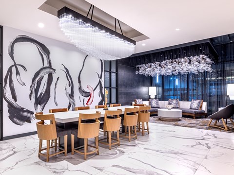 A modern dining room with a large table and chairs.