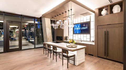A modern kitchen with a dining table and chairs.