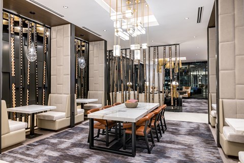 A modern dining area with a long table and chairs.