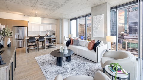 A modern living room with a large window overlooking the city.