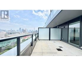 A balcony with glass railings overlooking a cityscape.