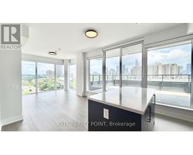 A spacious kitchen with a view of the cityscape.