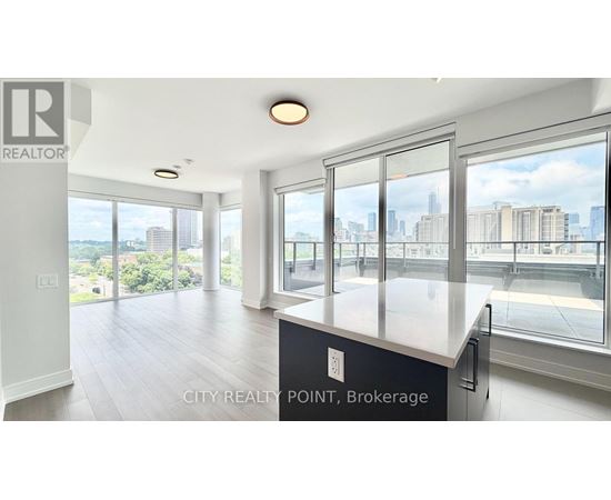 A spacious kitchen with a view of the cityscape.
