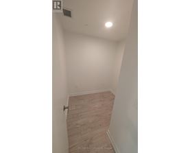 A room with a wooden floor and white walls.