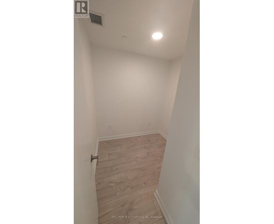 A room with a wooden floor and white walls.
