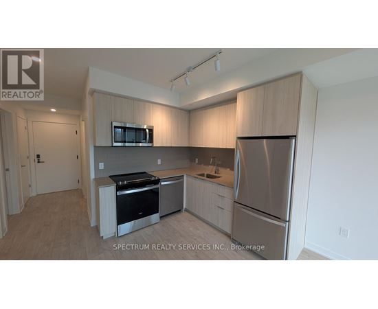 A kitchen with wooden cabinets and stainless steel appliances.