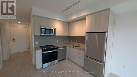 A kitchen with wooden cabinets and stainless steel appliances.