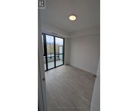 A room with a wooden floor and a sliding glass door.