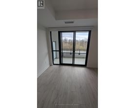 A room with a sliding glass door leading to a balcony.