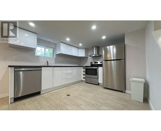 A modern kitchen with stainless steel appliances and white cabinets.