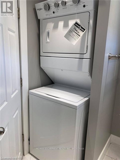 A white oven and dishwasher are in a small kitchen.