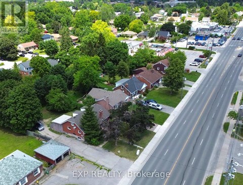 A real estate company logo is on a picture of a neighborhood.