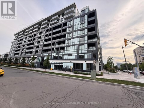 A modern multi-story building with a glass facade is the main focus of the image.