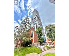 A church with a tall building behind it.