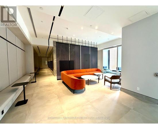 A modern living room with a black and orange sofa.