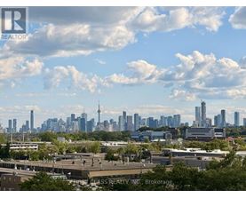 A cityscape with a mix of modern and older buildings under a partly cloudy sky.