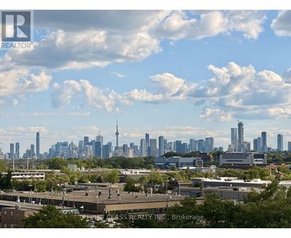 A cityscape with a mix of modern and older buildings under a partly cloudy sky.