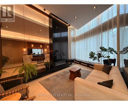 A modern living room with a large couch and a television.