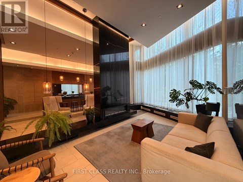 A modern living room with a large couch and a television.