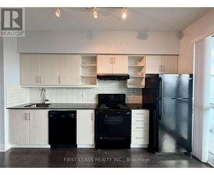 A kitchen with black appliances and white cabinets.