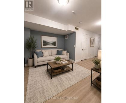 A living room with a couch, coffee table, and a painting on the wall.