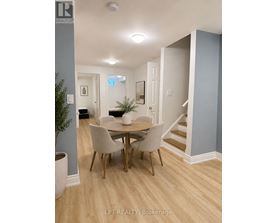 A dining room with a table and chairs.