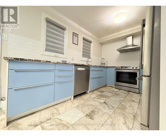 A kitchen with blue cabinets and a tiled floor.
