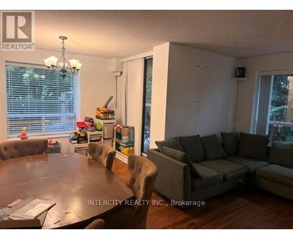 A living room with a brown table and grey couches.