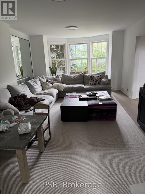 A living room with a grey couch and a coffee table.