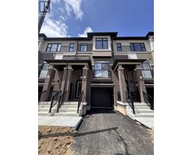 A modern two-story residential building with a black gate entrance.