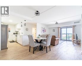 A well-lit, spacious kitchen and dining area with modern furniture.