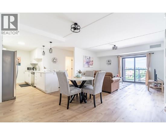 A well-lit, spacious kitchen and dining area with modern furniture.