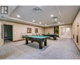 A room with a pool table and a carpet.
