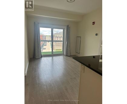 A room with a sliding glass door leading to a balcony.