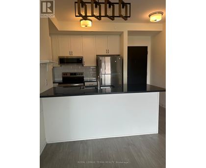 A kitchen with a stove top oven, microwave, and refrigerator.